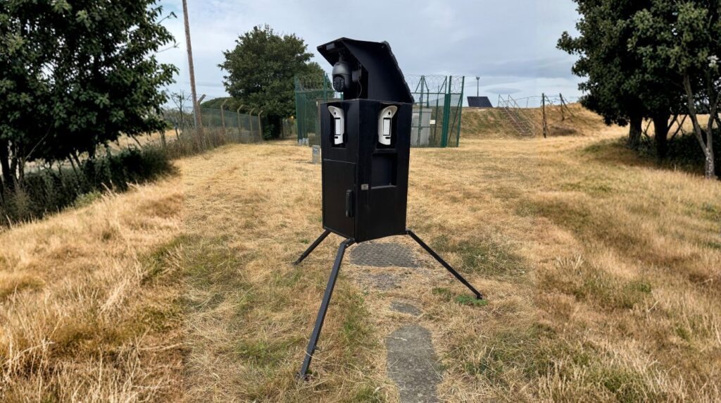 SkyGuard SKY-RT perimeter detection unit mounted on a construction site boundary with SKY-ST CCTV tower visible in background